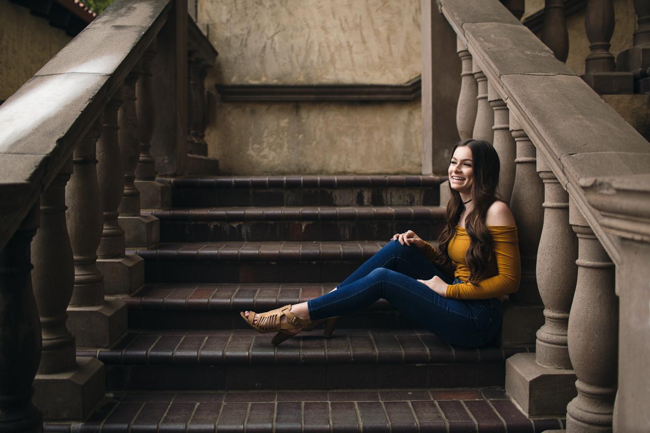 Smiling teen sitting on outdoor steps