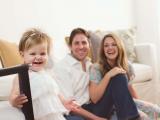 Happy toddler with parents by Sunny Mays