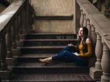 Smiling teen sitting on outdoor steps
