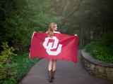 Oklahoma U bound graduating teen girl with OU Flag in Trophy Club Texas